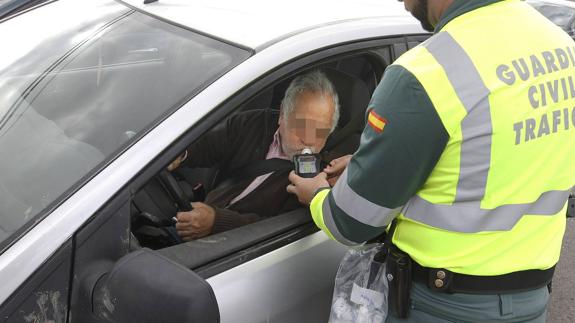 Guardia Civil officer breathalysing a driver. 