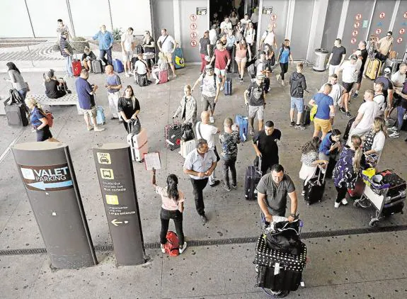 Tourists outside the Arrivals area at Malaga Airport.