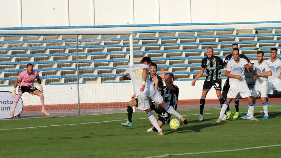 Marbella's Manel tries to get his shot away in the penalty area.