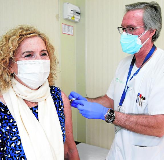 A woman is given the flu vaccine. 