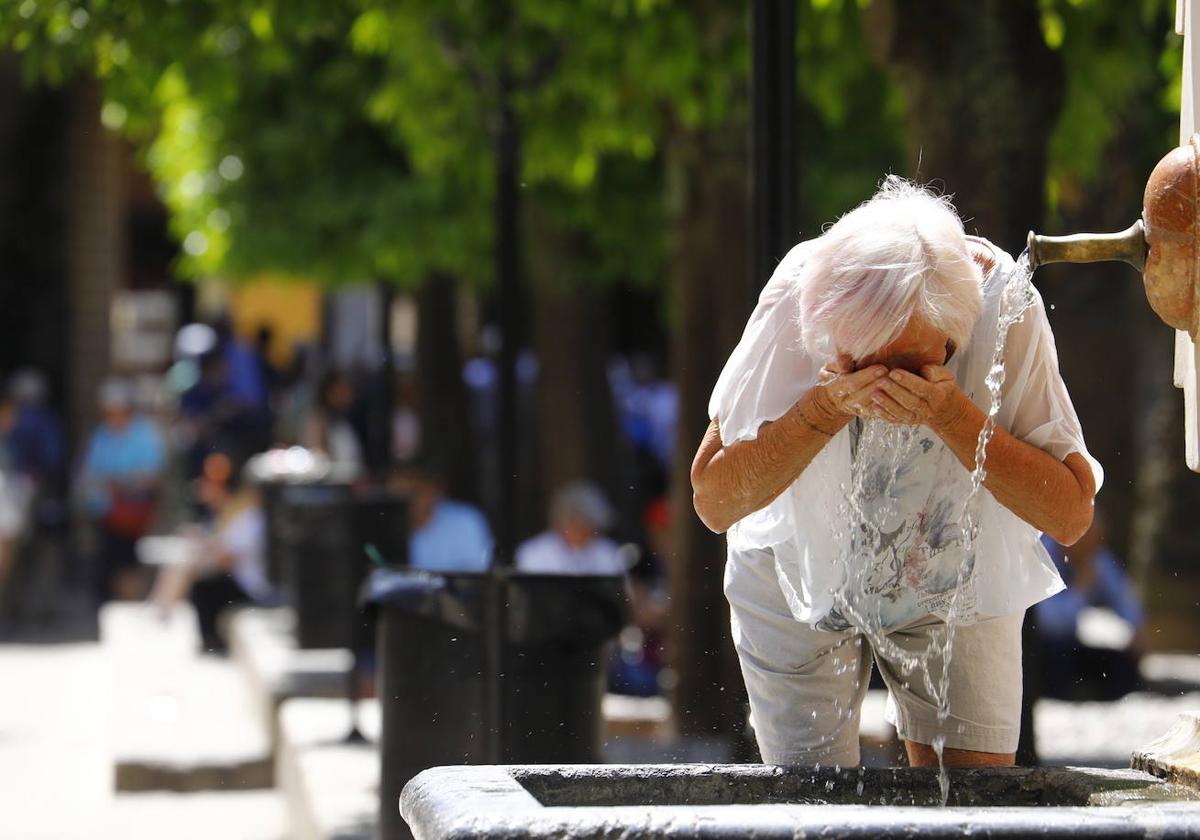 Persona se refresca con agua de una fuente ante las jornadas de calor