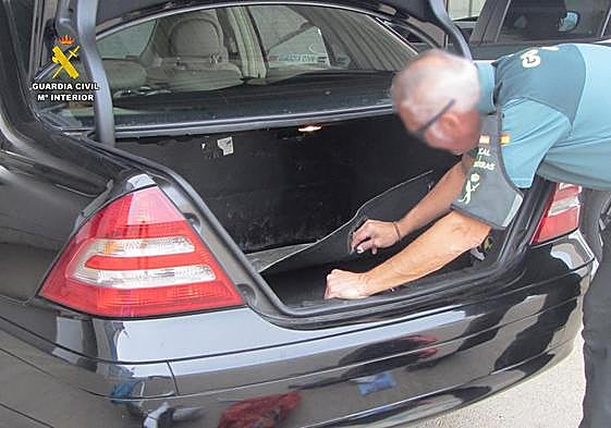 Un agente de la Guardia Civil investiga un vehículo.