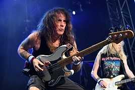 Steve Harris tocando el bajo con su característico estilo.