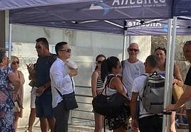 Una persona se abanica con una gorra en el acceso al castillo de Santa Bárbara.