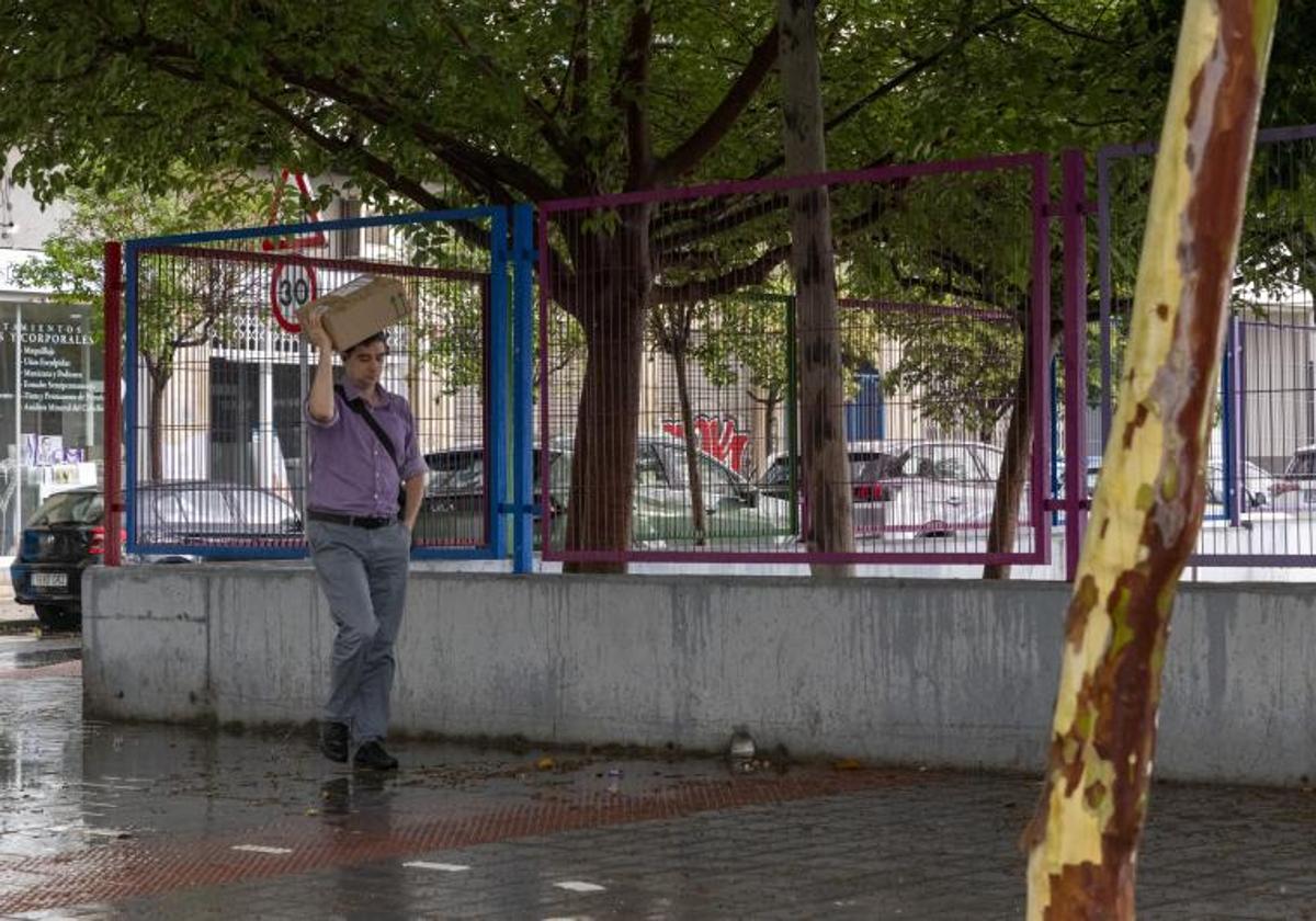 Un hombre pasea por Alicante bajo la lluvia.