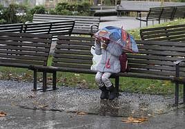 Una persona se protege de la lluvia con un paraguas.