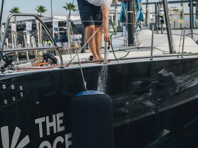 Una tripulante limpia el casco del barco