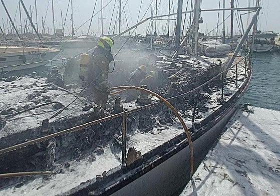 Efectivos de Bomberos, en el barco incendiado.