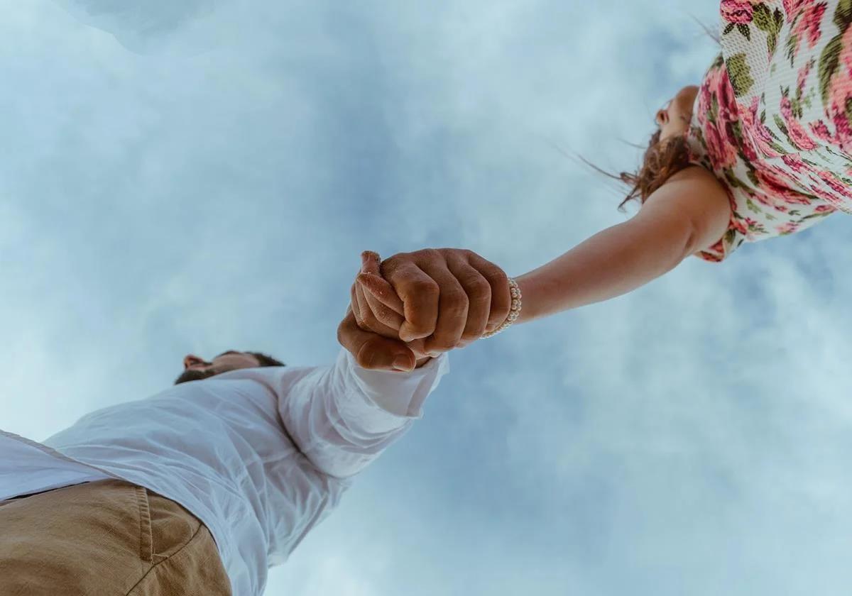 A couple walks hand in hand.