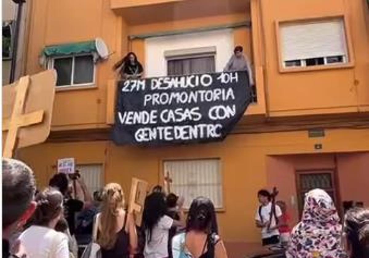 Activists display a banner at Olga's residence.
