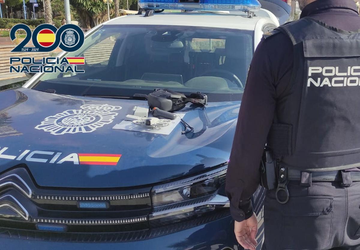 An officer from the National Police's Air Unit in Alicante alongside the drone seized at the port.