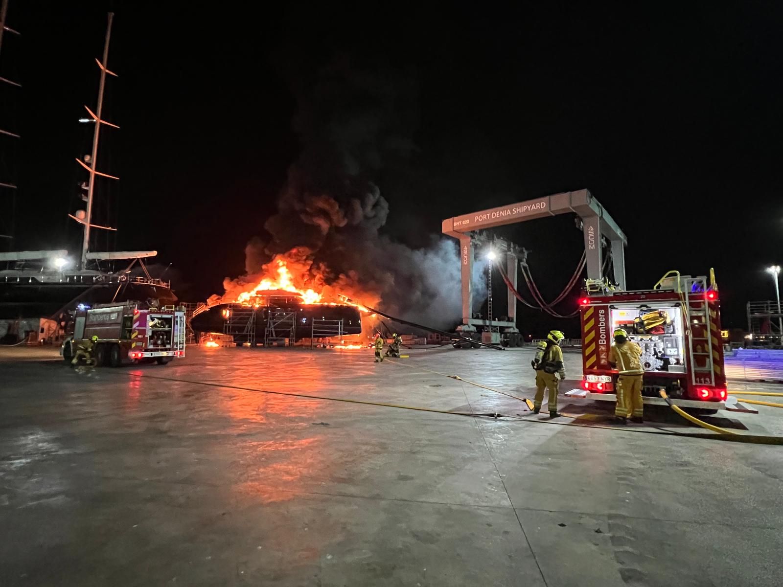 Catamaran engulfed in flames at the port.