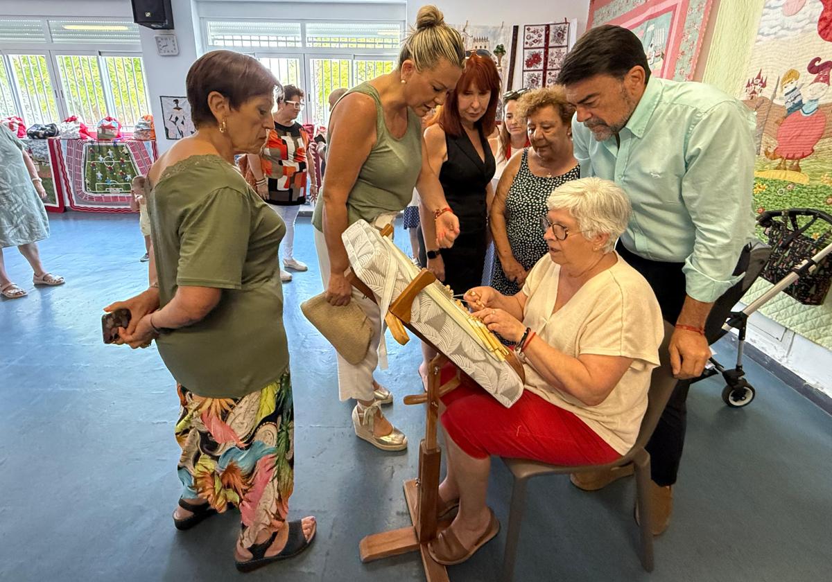 Mayor Luis Barcala observes lace-making at the San Gabriel Senior Centre.