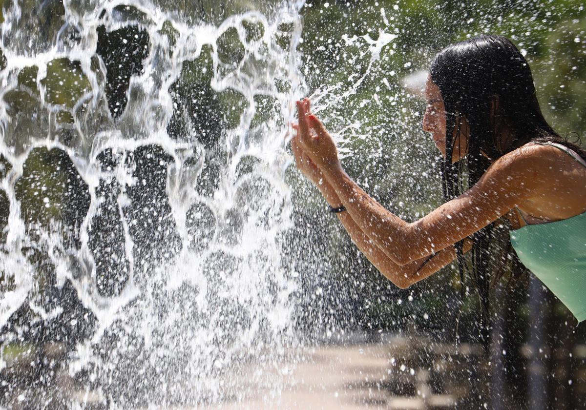 Woman cooling off in a fountain
