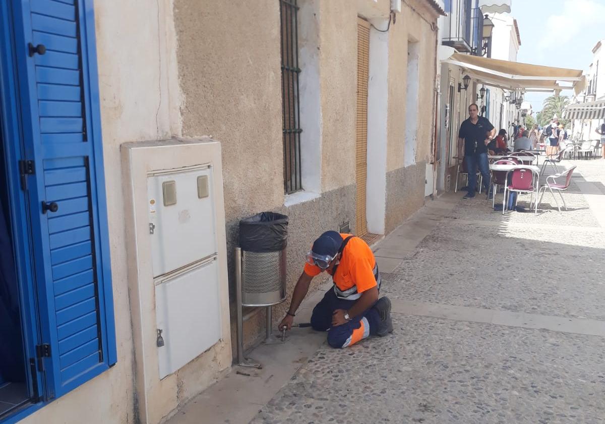 Municipal worker performing cleaning tasks on the island.