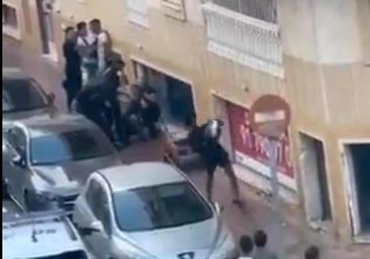 A young man throws a garbage bag at the officers in Torrevieja.