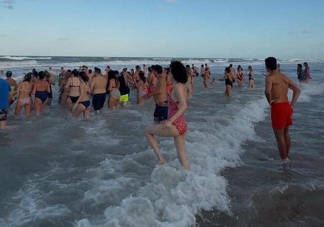A hundred people bathe at Babilonia Beach.