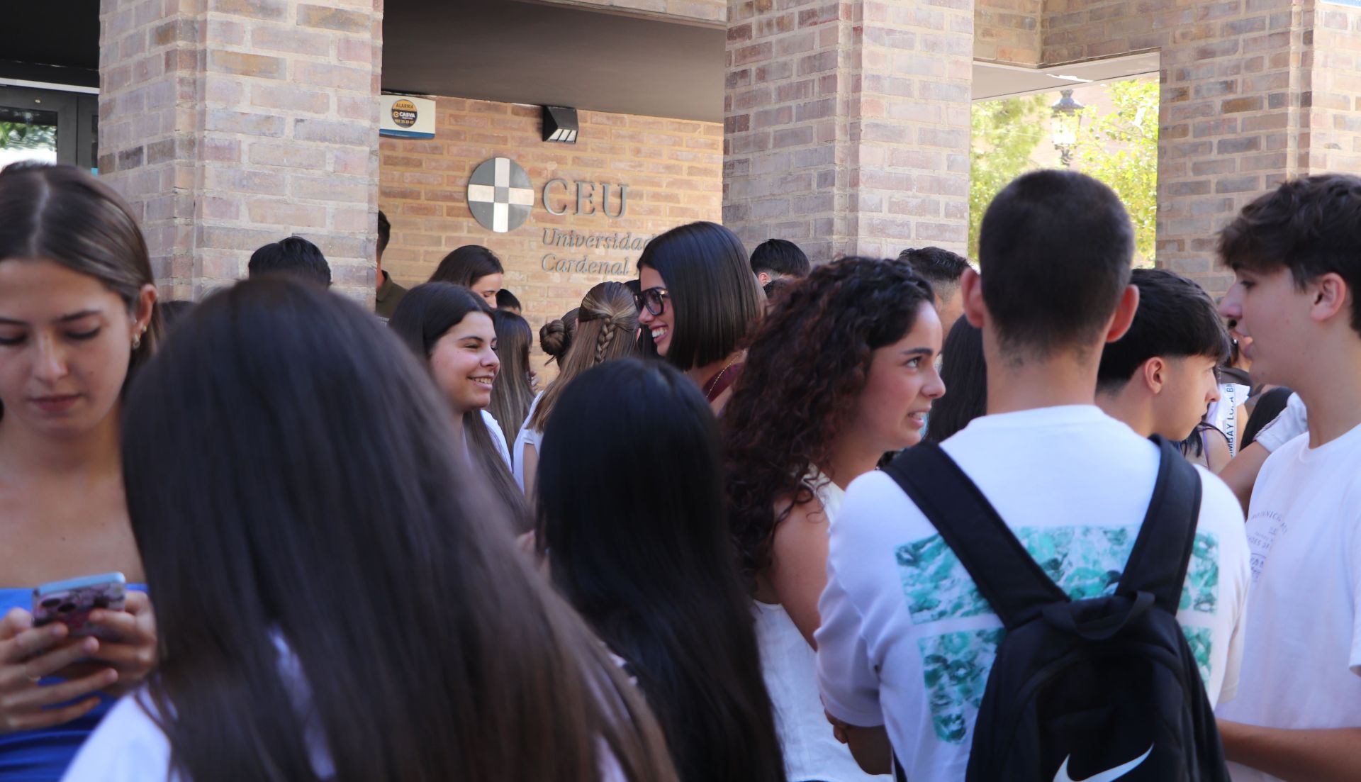 Estudiantes se reúnen en las puertas del edificio.