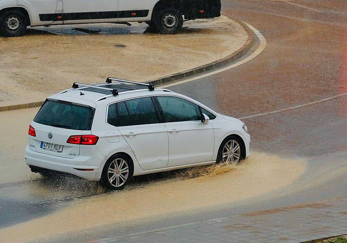 A car in a flooded street.