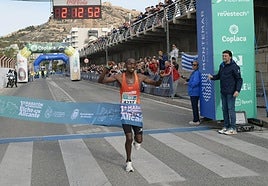 El keniata Kipkiriu Langat cruza la línea de meta como campeón de la maratón internacional Elche-Alicante.